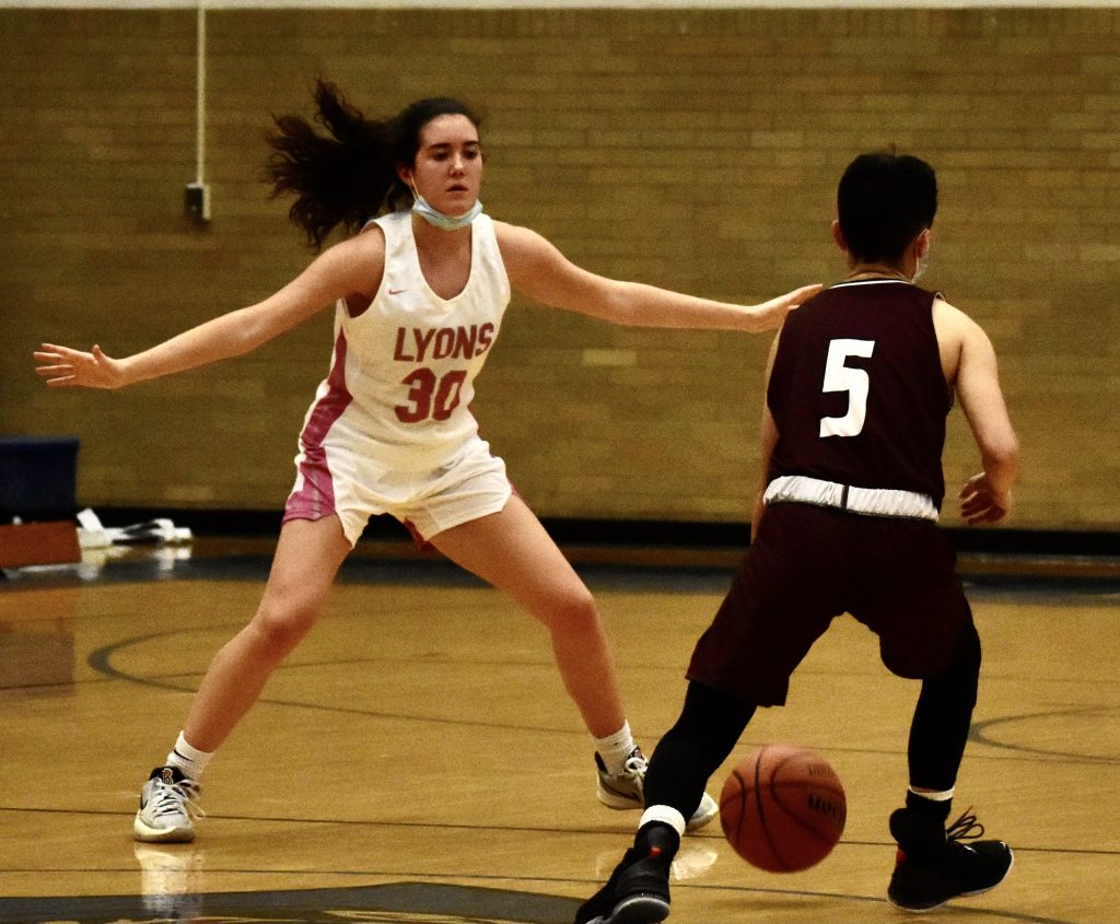 Lyons sophomore Erin O’Brien, who scored 13 points, guards Argo senior Abby Gamboa during the Lions’ 73-46 victory. Photo by Steve Metsch 