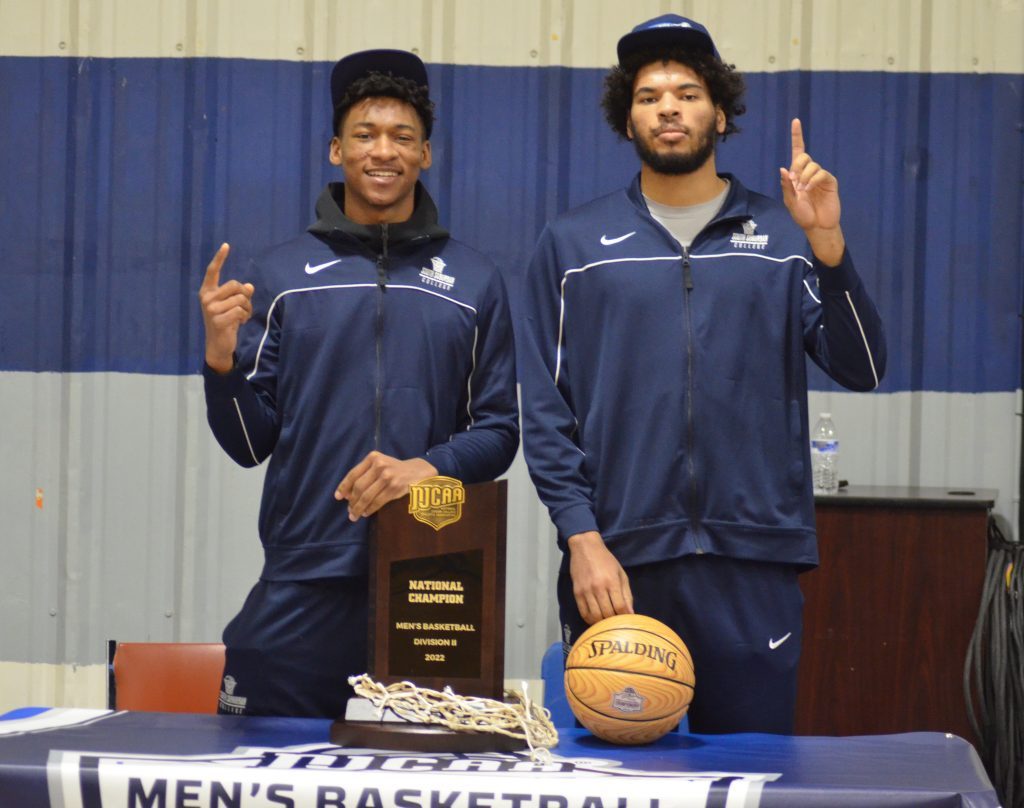 Catalyst Maria graduate Jonathan Brundidge (left) and St. Rita alum Cameron Bartmann pose with the NJCAA National Championship trophy on Sunday as South Suburban College won the title the night before. Photo by Jeff Vorva