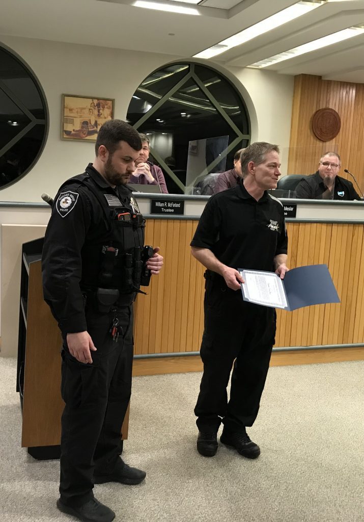 Chicago Ridge Police Chief Jim Jarolimek praises the life-saving work of Detective David Jenen (left), who was honored at the March 1 Village Board meeting for safely diffusing a volatile situation in Crestwood involving a suicidal man threatening to shoot police. (Supplied photo)