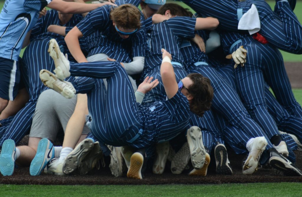 Nazareth's Lucas Smith takes a tumble during the celebration pile Saturday after Nazareth Academy won the Class 3A state championship. Photo by Jeff Vorva