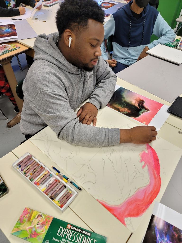 EPCHS senior Elliot Douglas draws with oil pastels inspired by Astrophotography in an art class at EPCHS. (Supplied photos)