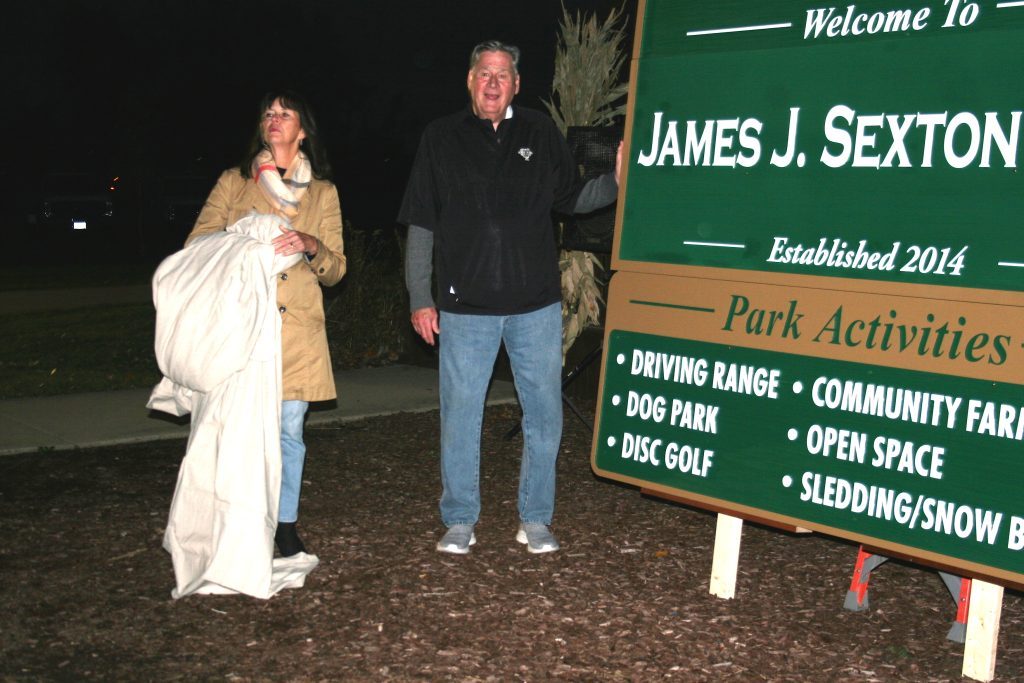 Evergreen Park Mayor Kelly Burke joins former Mayor James Sexton after the sign was unveiled officially changing the name of 50-Acre Park to James J. Sexton Park. The ceremony took place October 27 at the park. (Photos by Joe Boyle)