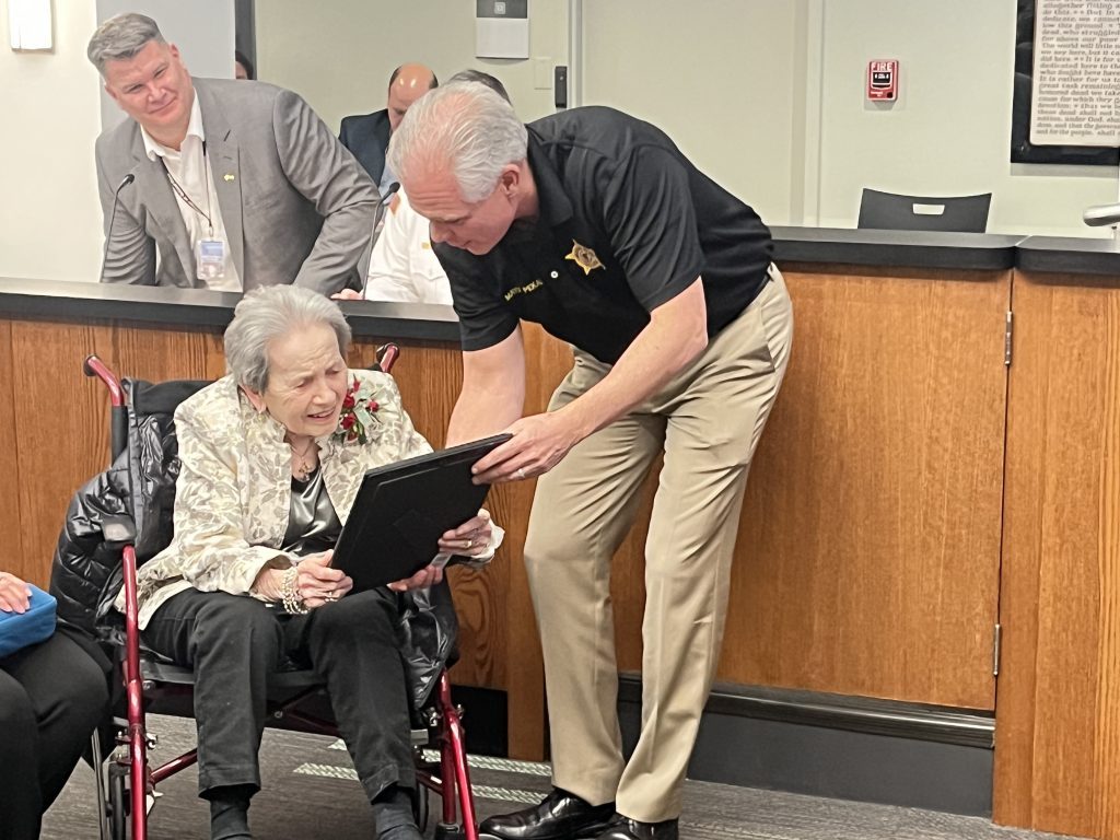 Mayor Keith Pekau presents an award to 100-year-old Lea Luchini at the Feb. 20 board meeting. (Photo by Jeff Vorva)