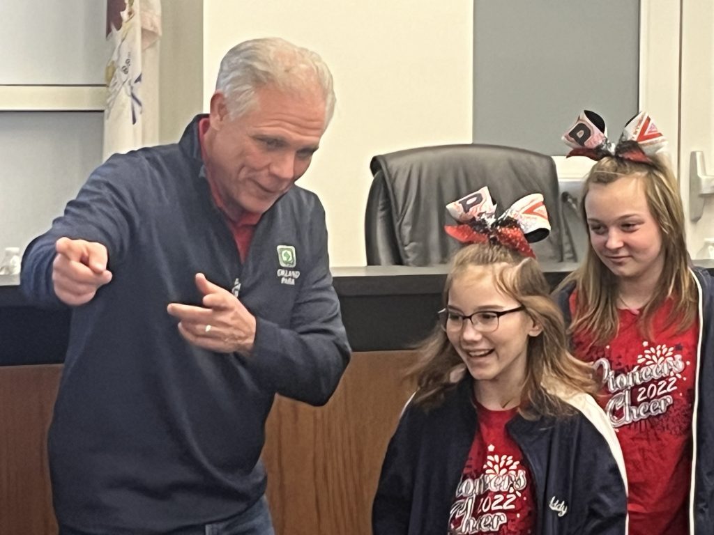 Orland Park Mayor Keith Pekau directs some of the state champion Pioneer cheerleaders during Monday night's board meeting. Photo by Jeff Vorva