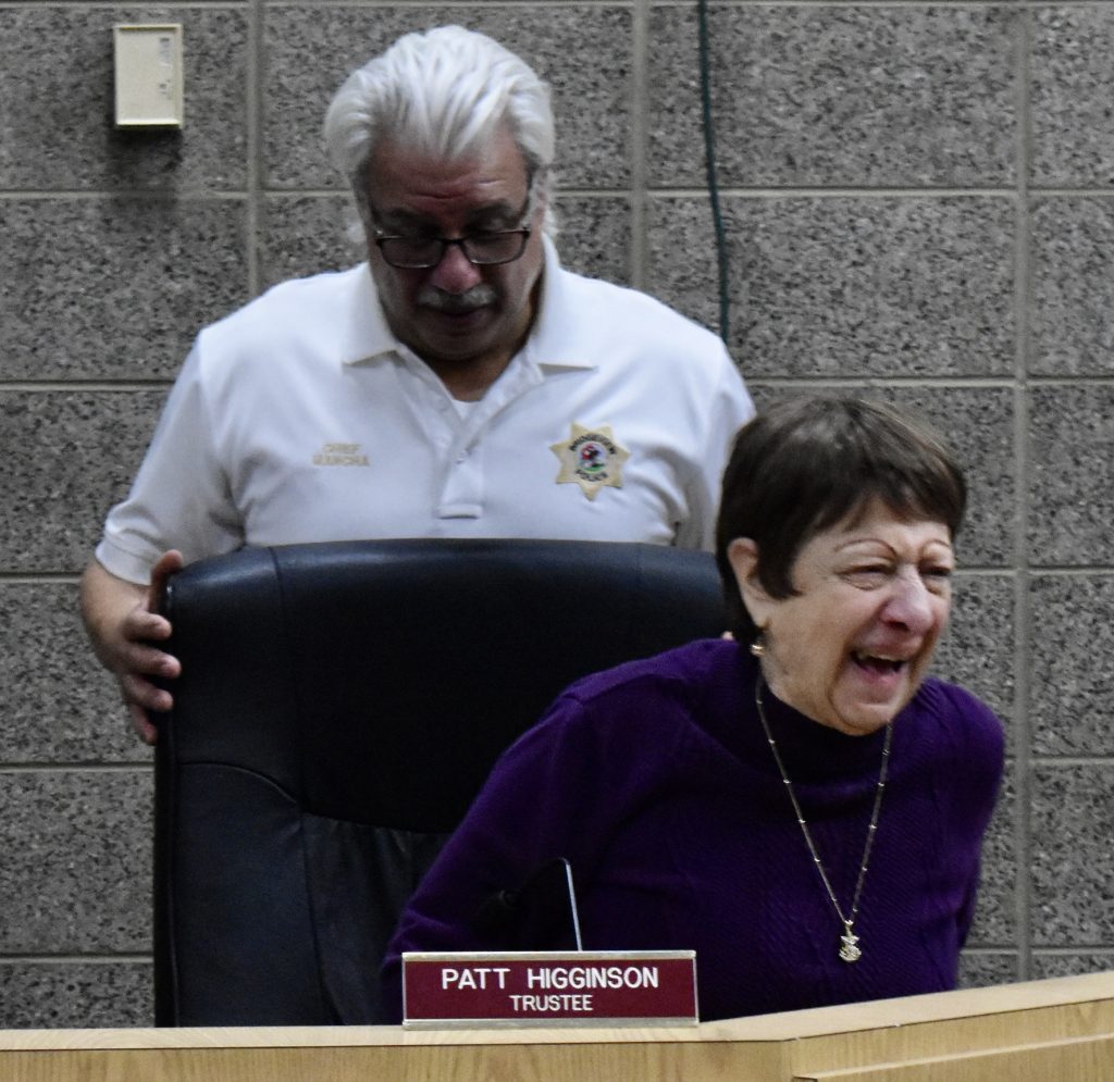 Bridgeview Village Trustee Patricia Higginson laughs as Police Chief Ricardo Mancha adjusts her chair at the board meeting, (Photos by Steve Metsch) 