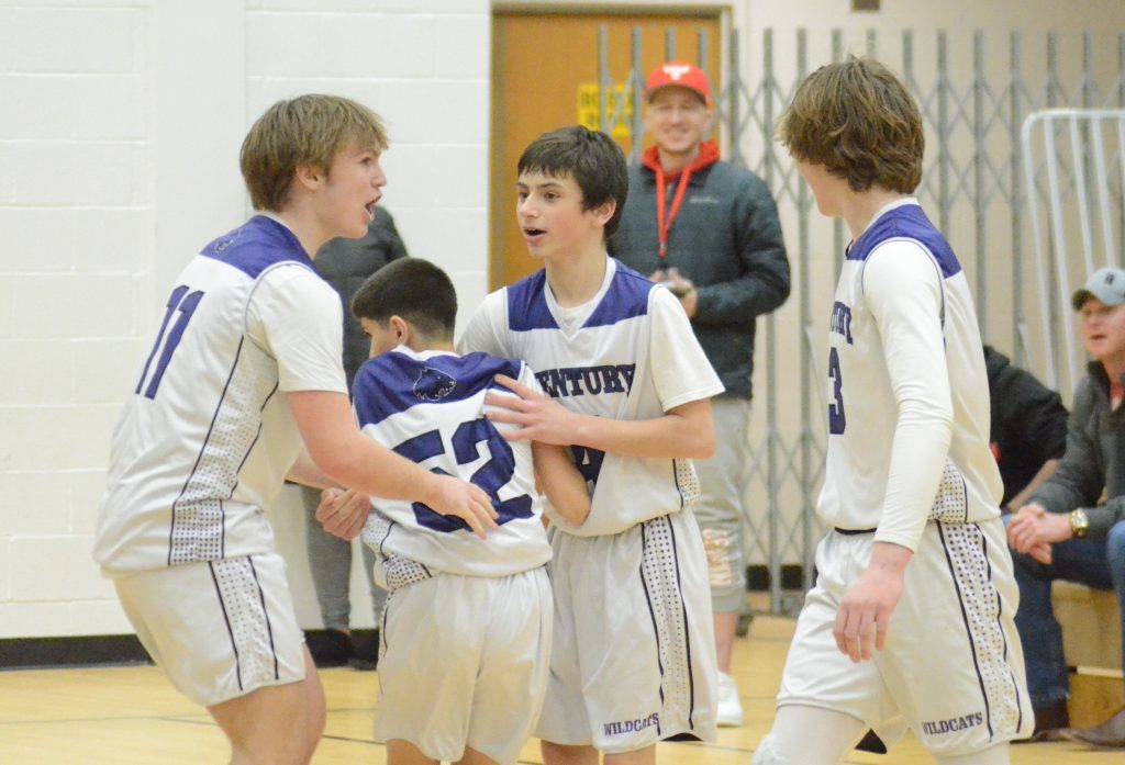 Century's Zedan Said (No. 52) starts to get mobbed by his teammates after he hit a go-ahead 3-pointer with four seconds left in the SWIC eighth-grade championship. Photo by Jeff Vorva