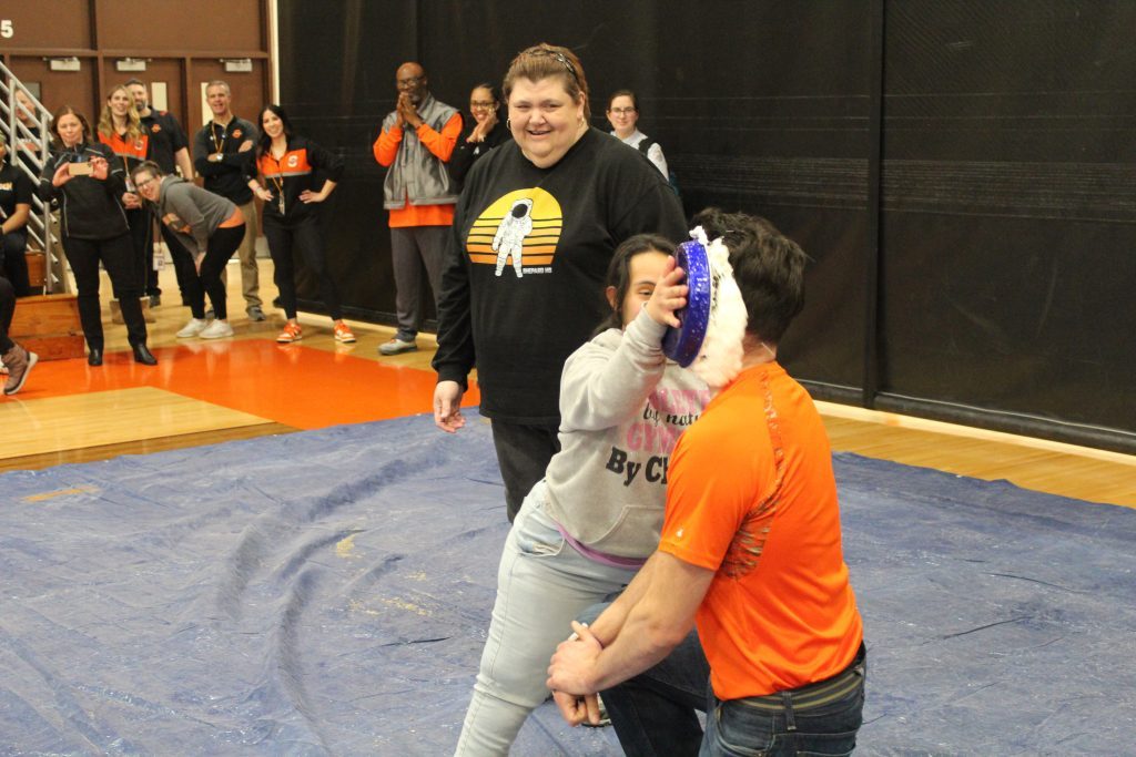 Shepard High School teacher Joe Lerner receives a pie-in-the-face at the Respect Week assembly.  Lerner and other staff members volunteered to get hit with pastry to raise money for Special Olympics. (Supplied photo)