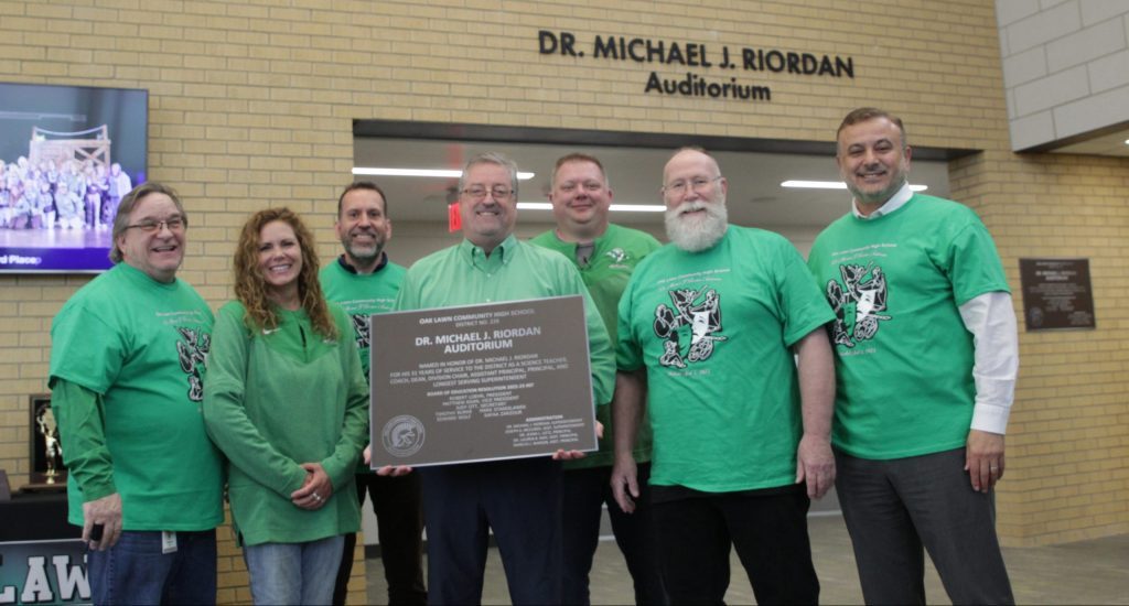 OLCHS school board members present retiring Supt. Michael Riordan with a plaque after dedicating the new Performing Arts Center auditorium in his honor. (Supplied photos)