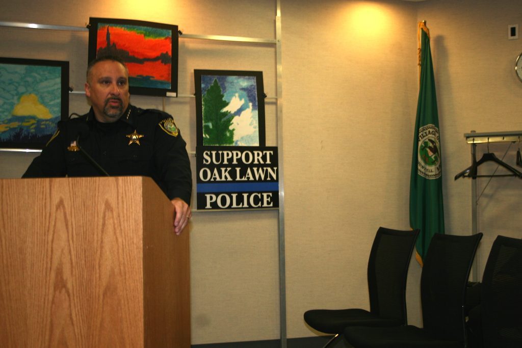 Police Chief Daniel Vittorio announced at the June 13 Oak Lawn Village Board meeting that yard signs supporting the police can be purchased through the Oak Police Club or at the Village Hall. One of the signs is located just to the left of Vittorio. (Photo by Joe Boyle)