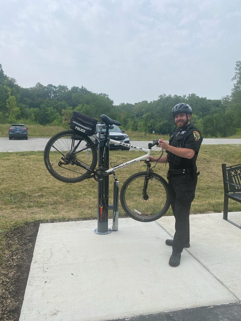 Palos Park Police Officer Cohen Piechocinski shows off the new bicycle Fix-It Station at the Cal-Sag Trail. (Photo supplied by Palos Park Police Department) 