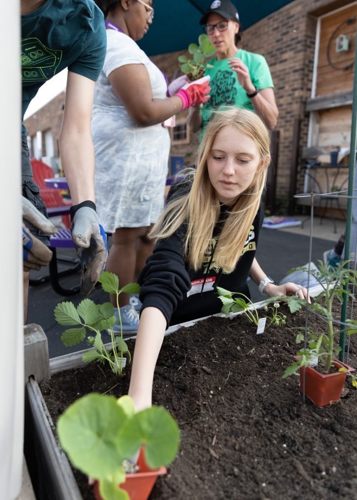 Bridge Teen Center Founder, Priscilla Steinmetz, shares gardening tips with students while planting The Bridge Teen Center's vegetable garden, complete with tomatoes, cucumbers, and more. (Supplied photos)