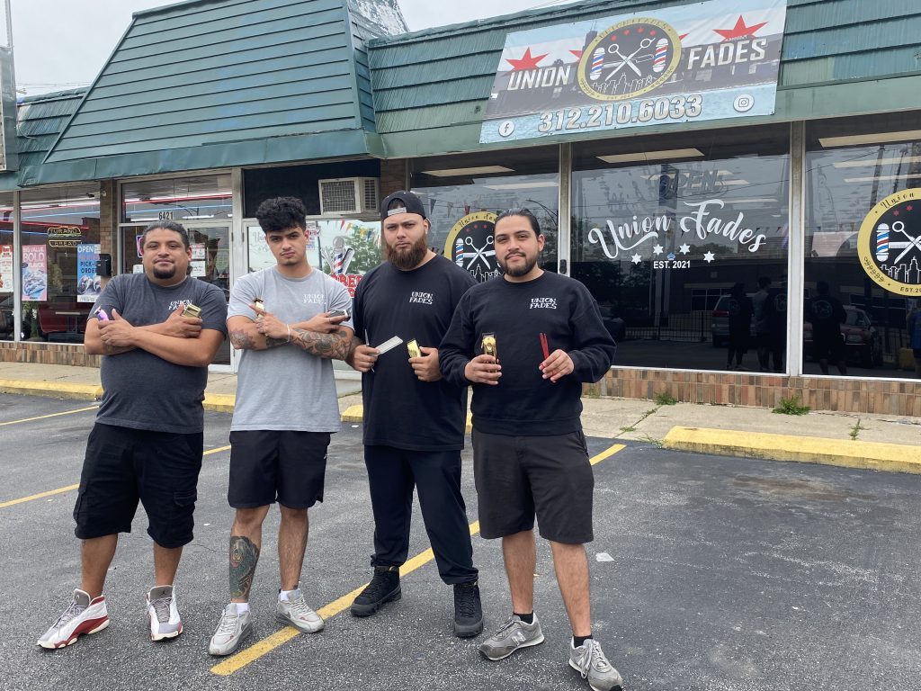 Union Fades founder and owner Cristihan Barcenas and three of his barbers--Jose Barcenas, Ramiro Rivera and Omar Aldrete—pause to pose for a photo outside his shop, 6425 W. Archer. All four men are Kennedy High School alumni, as are the
other people employed at the shop: Jonathan Gomez, Joanna Aldrete and Elian Garcia. – Photo by Cosmo Hadac