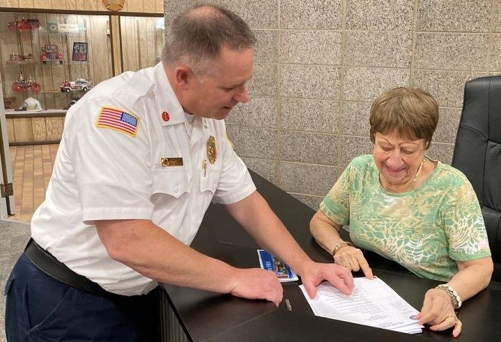 Bridgeview Fire Chief Keith Grzadziel reviews with Trustee Pat Higginson an internship program the village entered into with Moraine Valley Community College. (Photo by Steve Metsch)