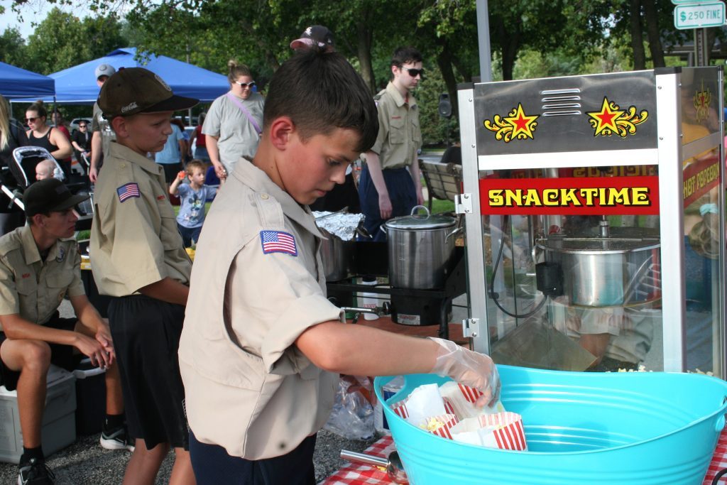 Jack McCormick, 11, a member of Boy Scout Troop 596, makes popcorn during the Oak Lawn National Night Out on August 1 in the village's Municipal Hall parking lot. (Photo by Joe Boyle)