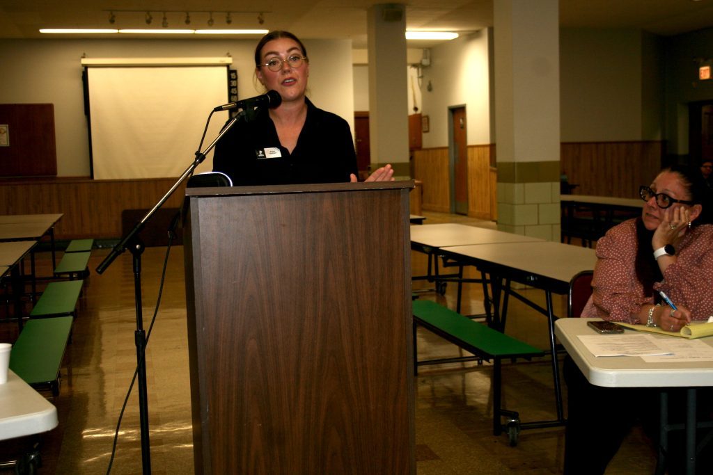 Ariel Berchtold, marketing manager for the Better Business Bureau, talked to residents and members of the Archer Heights Civic Association, warning them about a series of phone scams and fraudulent emails. Photo by Joe Boyle