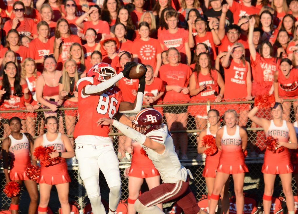 Marist sophomore wide receiver Stephen Brown makes a catch over a Brother Rice defender during the RedHawks' 30-24 win over the Crusaders on Sept. 1. Photo by Jason Maholy