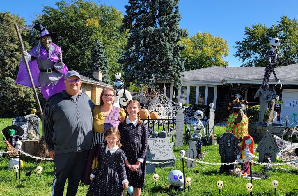 The Stolarski family stands in front of their incredible yard display. Pictured from left: Chris, Amanda, Josephine, 5, and Annabelle, 11. (Supplied photo)