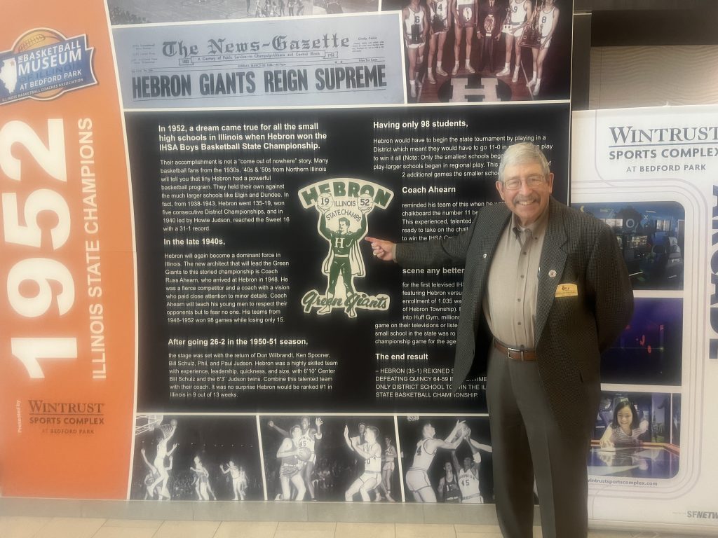 Basketball Museum of Illinois President Bruce Firchau poses in front of a huge historical display on Oct. 5 at the Wintrust Sports Complex in Bedford Park. Photo by Jeff Vorva