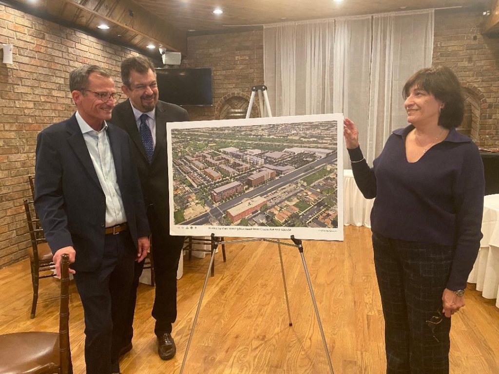 UBAM Executive Director Anita Cummings discusses LeClaire Courts redevelopment plans with Mark Kirincich and Bill Velazquez of the Cabrera Capital, the company handling the project. --Photo by Cosmo Hadac