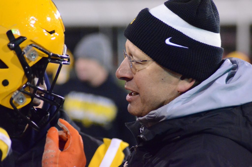 St. Laurence assistant coach Frank Lenti, a longtime fixture on the sidelines in state championship games when he was at Mount Carmel, fires up running back Aaron Ball before the Vikings take on Rochester for the Class 4A title on Nov. 24. Photo by Jeff Vorva