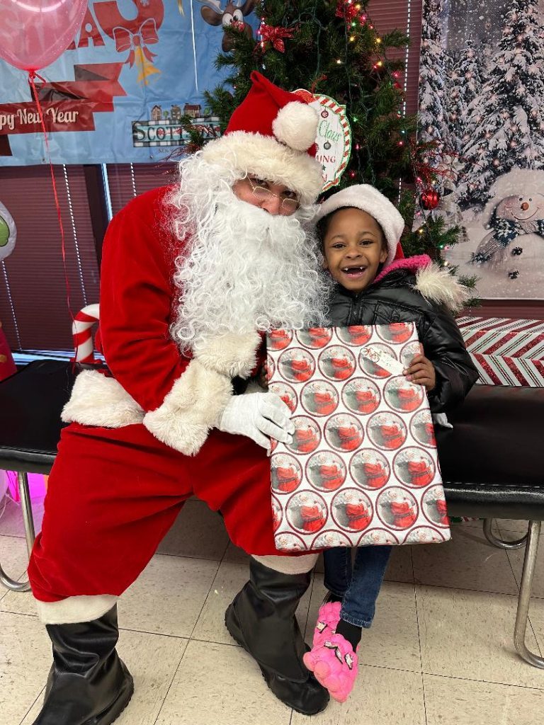 Englewood resident Brielle Herring, 6, was one of more than 300 children who met with Santa Claus and received a gift at the Christmas event hosted by Kourtney's Kindness and the Scottsdale Neighborhood Watch. More photos at southwestregionalpublishing.com. --Greater Southwest News-Herald photos by Kelly White