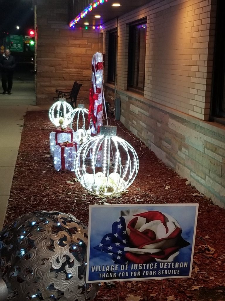 Christmas decorations light up the sidewalk in front of Justice Village Hall. (Photos by Carol McGowan)