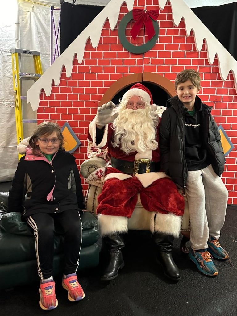 Penelope Maka, 7, of Palos Heights, and her brother, Jacob, 10, met with Santa at the Palos Heights Kris Kringle Market on Friday night. (Photos by Kelly White)