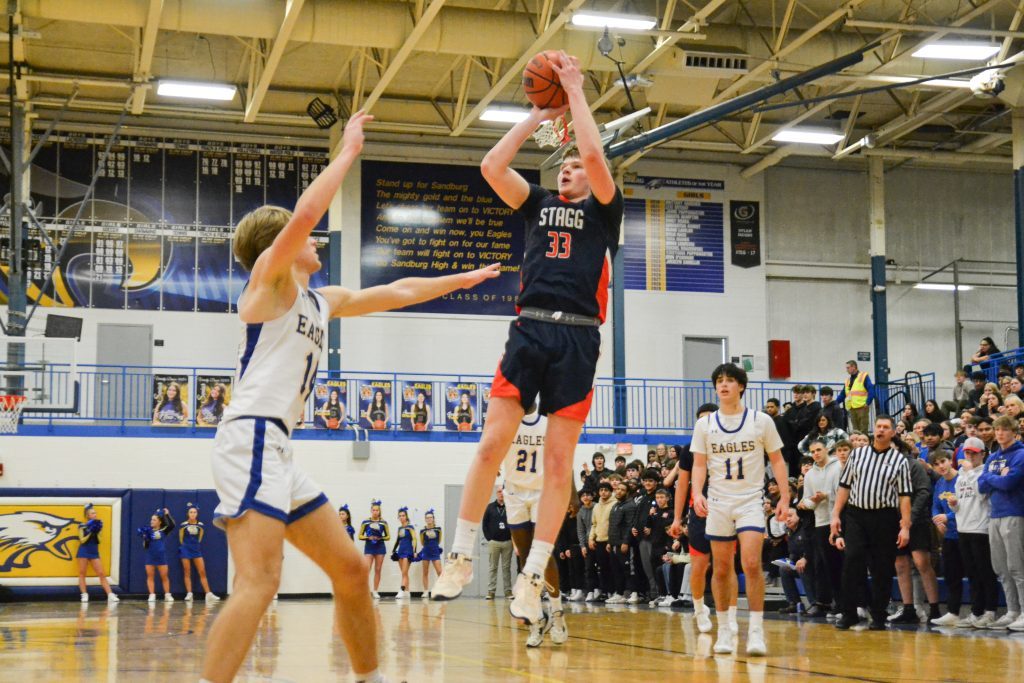 Stagg senior Connor Williams attempts a shot over Sandburg’s Paulius Mizeras during the Eagles’ 82-78 win over the Chargers on Jan. 23. Photo by Xavier Sanchez