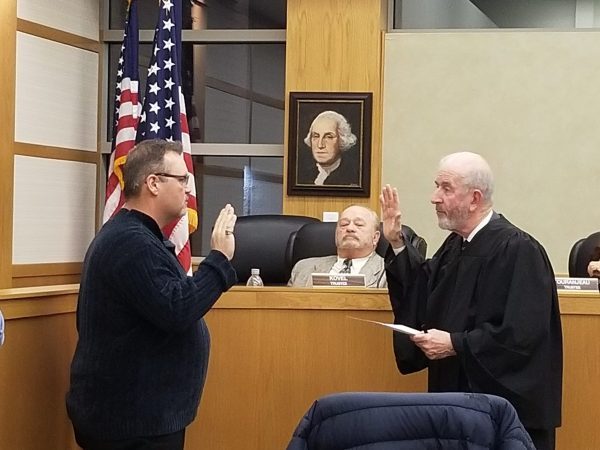Todd Haizlip (left) is sworn in by Hodgkins Village Attorney and retired Judge Pat Rogers. (Photo by Carol McGowan)