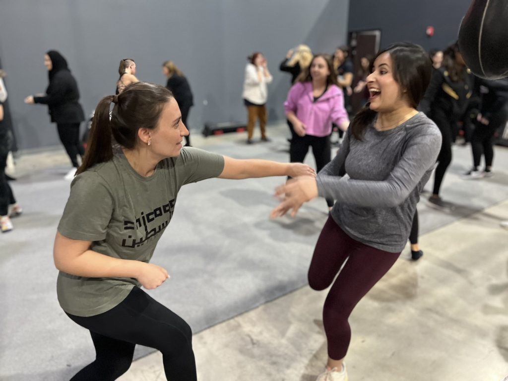 Two participants practice self-defense techniques at a Gaza relief seminar in Orland Park. (Photos by Nuha Abdessalam)