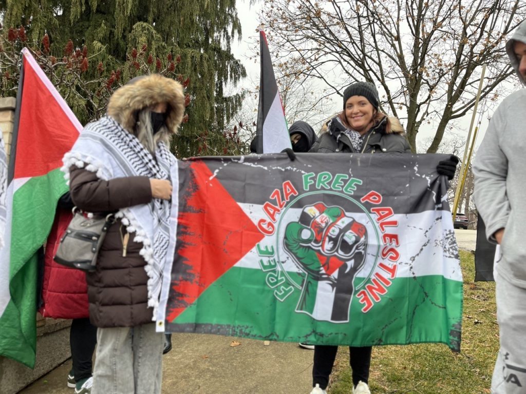 Supporters of the Gaber family show off a flag calling for a Free Gaza and a Free Palestine. (Photos by Nuha Abdessalam)