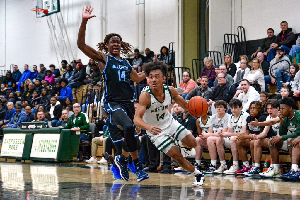 Evergreen Park senior Tre Dowdell crosses over a Hillcrest defender during the Class 3A Evergreen Park Regional championship game on Feb. 23. Photo by Xavier Sanchez