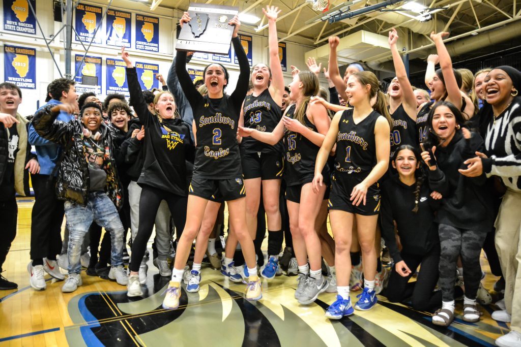 Sandburg players celebrate their Class 4A regional championship after defeating Romeoville in overtime on Feb. 15. Photo by Xavier Sanchez
