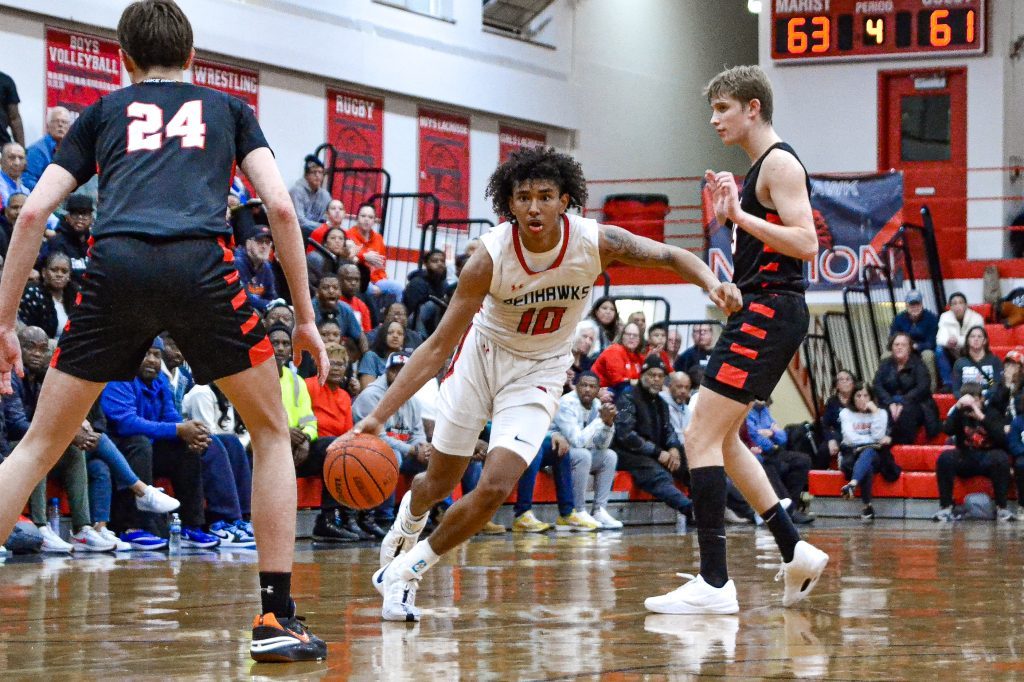 Marist senior guard Darshan Thomas makes a move toward the basket during the RedHawks’ 65-64 win over Benet on Feb. 2. Photo by Xavier Sanchez
