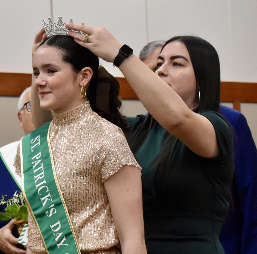 St. Patrick's Day Parade queen Bea Keenan is crowned by deputy city clerk Liz Cordova Wednesday night. (Photos by Steve Metsch) 