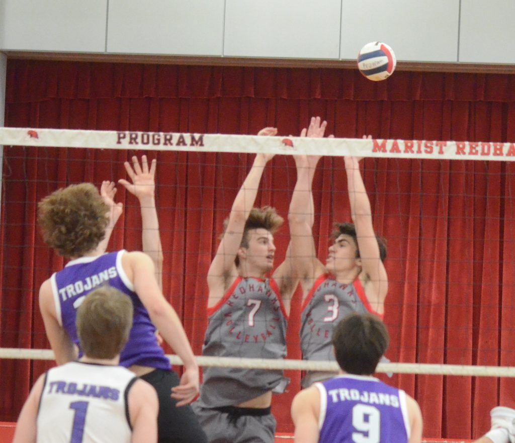 Marist's Jack Meader (left) and Nathen Toth face each other during a block attempt against Downers Grove North in the semifinals of the Marist Invitational on March 23. Photo by Jeff Vorva