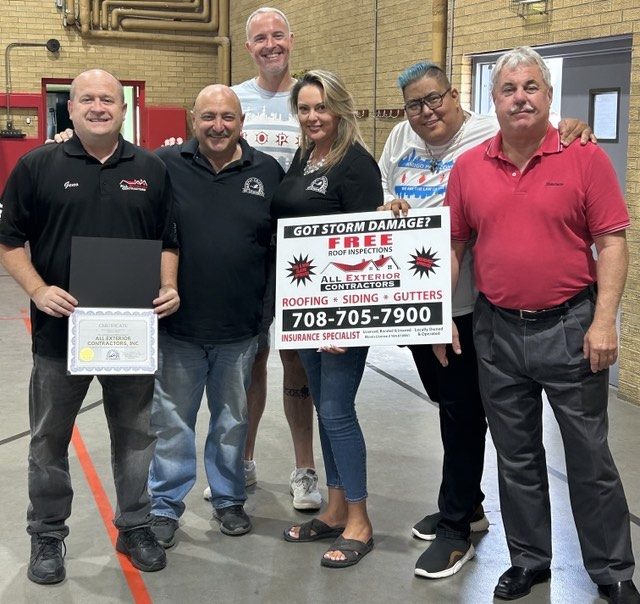 Geno Randazzo (left) and other community leaders last year, when All Exterior Contractors was named Midway Chamber of Commerce's Business of the Month for the third time. --Supplied photo