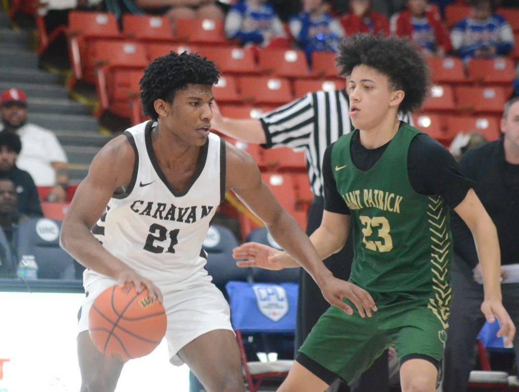 Mount Carmel's Cameron Thomas moves the ball against St. Patrick on March 4 in a supersectional win that sent the Caravan to the Class 3A semifinals. Photo by Jeff Vorva