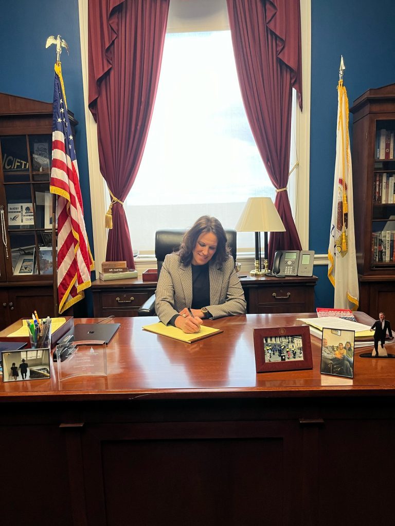 Priscilla Steinmetz, of Orland Park's Bridge Teen Center, has fun March 7 at Congressman Sean Casten's desk in Washington. (Bridge Teen Center photo)