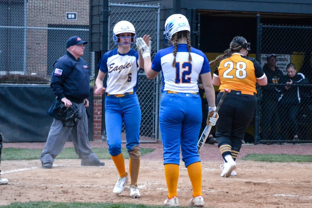 Sandburg sophomore Zoe Trunk high-fives teammate Grace Torgerson (12) after the former scored a run during the Eagles’ 9-1 win over Richards to open the 2024 season. Photo by Xavier Sanchez