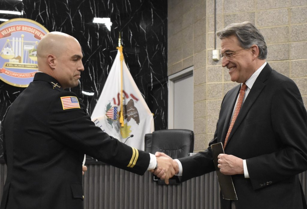 After he was sworn in as fire battalion chief, Jason Yerkovich shakes hands with Bridgeview Mayor Steve Landek. (Photo by Steve Metsch)