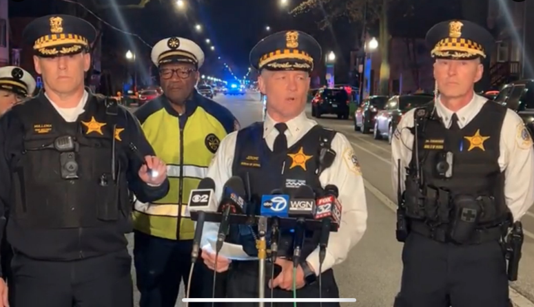 Flanked by other top local CPD officials, Area 1 Deputy Chief Don Jerome stands in the middle of Damen Avenue Saturday night as he leads a press briefing. --Supplied photo