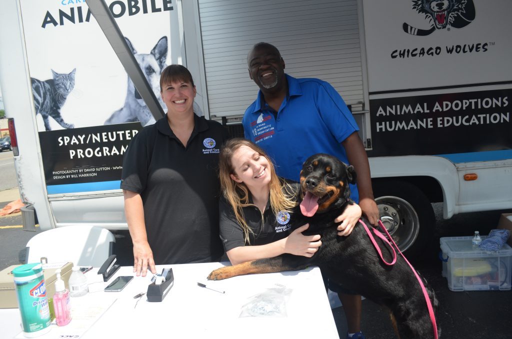 Eighteenth Ward Ald. Derrick G. Curtis hosts a popular pet vaccination event each year, and in years past led by example by bringing his dog, Sasha, who enjoyed the attention. --File photo
