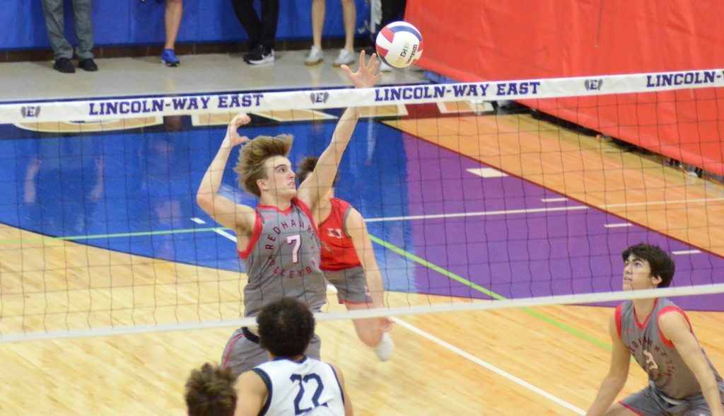 Marist middle hitter Jack Meador attacks against Glenbard West  in the championship match at the Lincoln-Way East Invitational on April 27 in Frankfort. Photo by Jeff Vorva