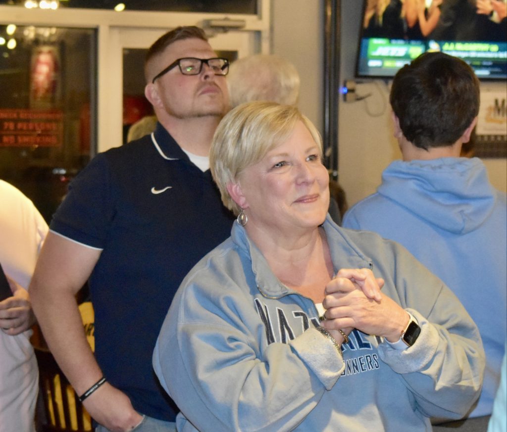 Nazareth Academy Principal Therese Hawkins and football offensive coordinator Casey Moran pay close attention to the drafting of J.J. McCarthy at The Stadium Club. (Photos by Steve Metsch)