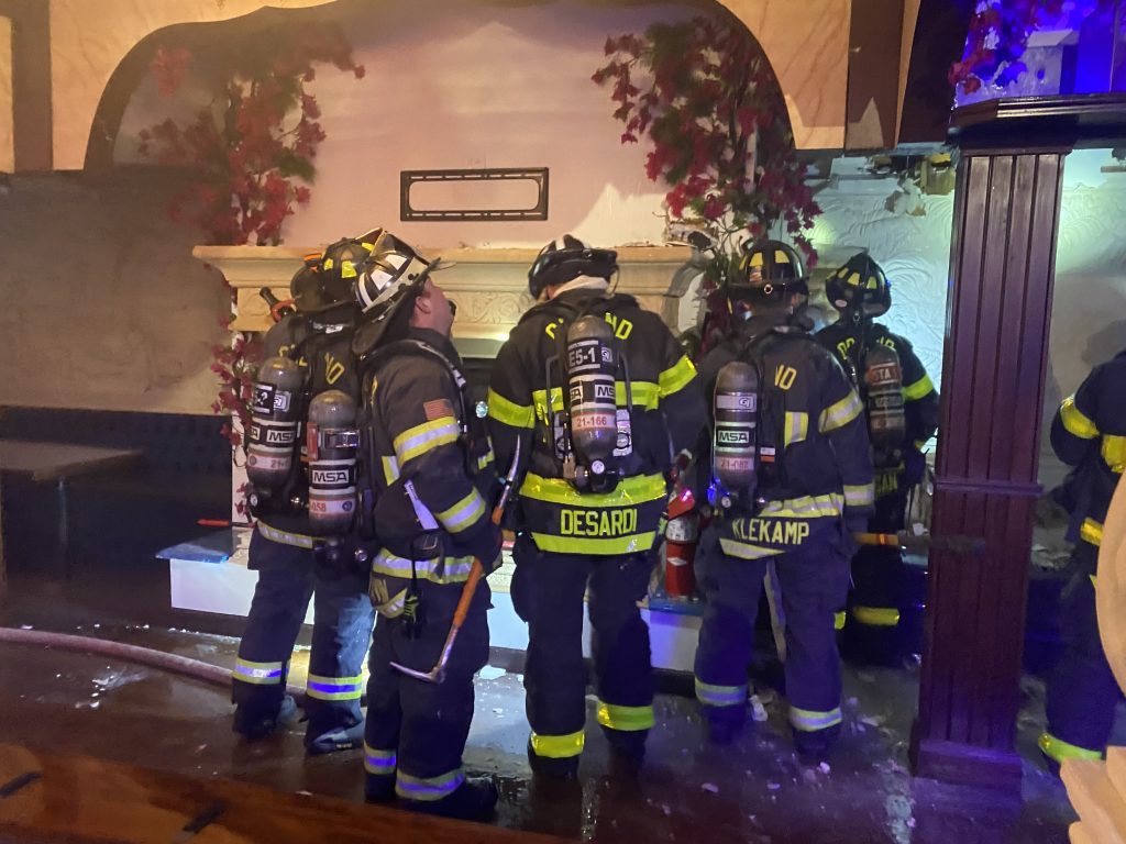 Firefighters inspect the Al Bahaar Restaurant, 39 Orland Square Dr., after extinguishing a fire that was inside the wall of the building and not readily seen. (Photo courtesy of the Orland Fire Protection District)