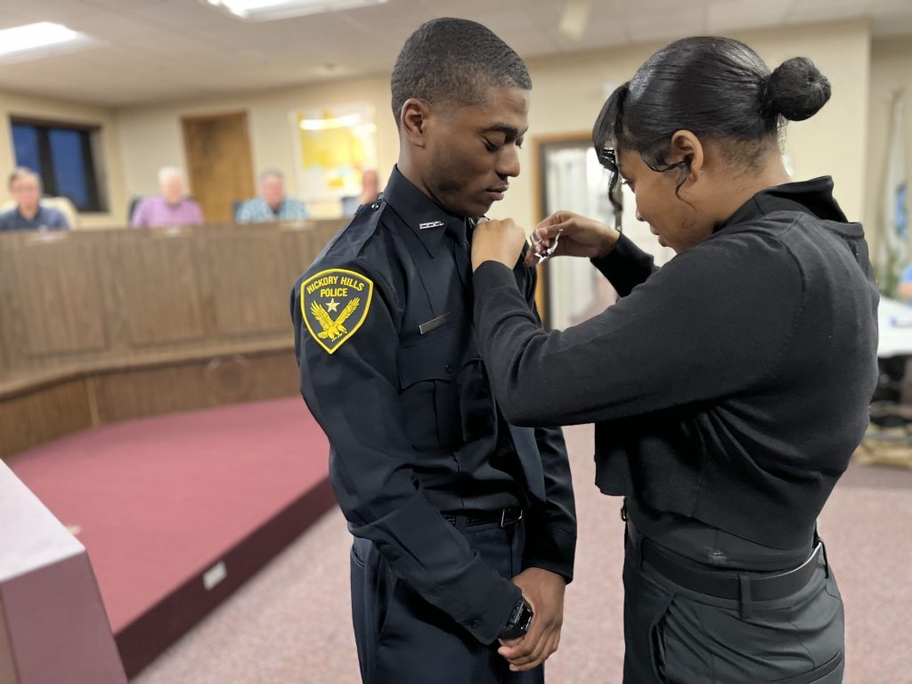 Andre Showers’ fiancée Destiny pins the police badge on his uniform at last week’s Hickory Hills City Council meeting. (Photos by Nuha Abdessalam)