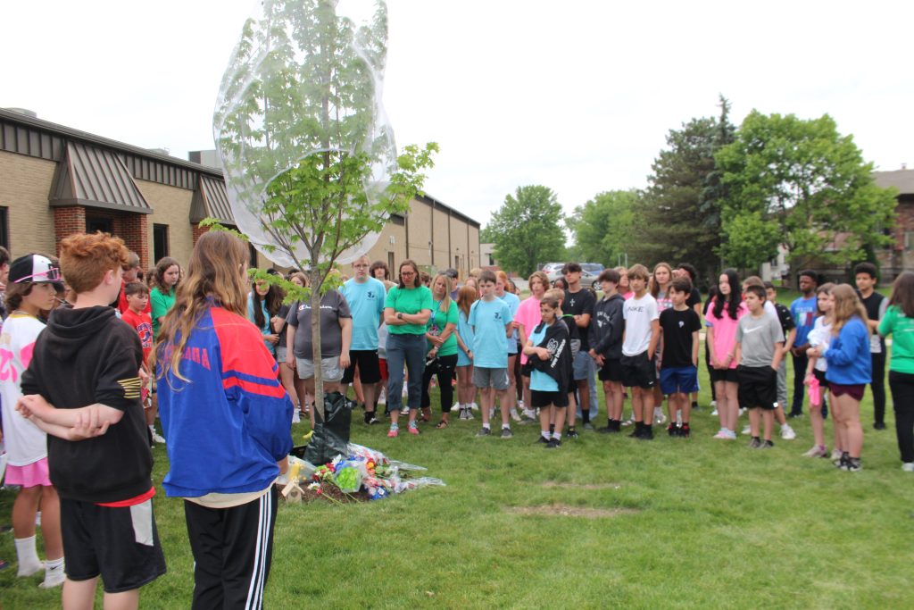 The Independence Junior High School community memorialized art teacher Mike Maholland by planting a memorial tree overlooking his art classroom. A moment of silence was held outside during the tree planting. (Supplied photos)