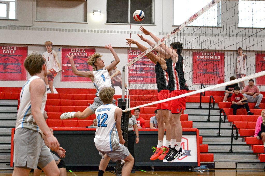 Nazareth’s David Brunke goes for a kill as Marist players try to block his attempt. Photo by Xavier Sanchez