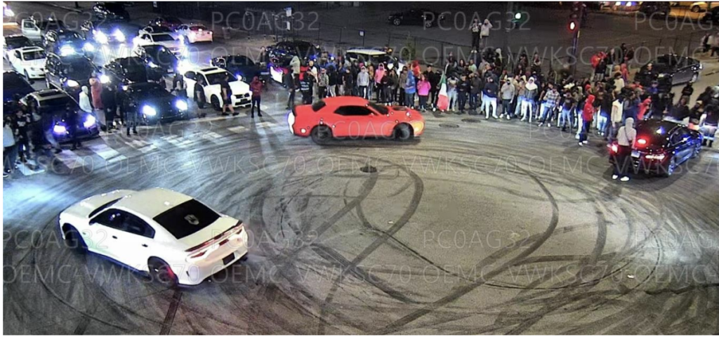 Surveillance footage shows the takeover of 59th and Western just after 3 a.m. Sunday, May 5. Guillermo Caballero’s black Honda Accord  is at the right of the circle. --Supplied photo